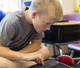 Blonde boy with Chromebook SouthEastPolkSchools BrookePavelPhoto161